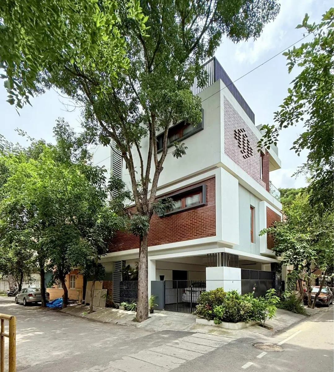 Bhoomi in Bengaluru, with white concrete frames and exposed brick façades